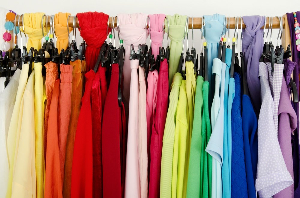 Close up on color coordinated clothes on hangers