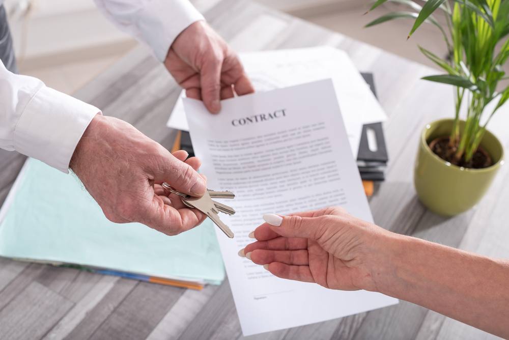 estate-agent-giving-house-keys-contract