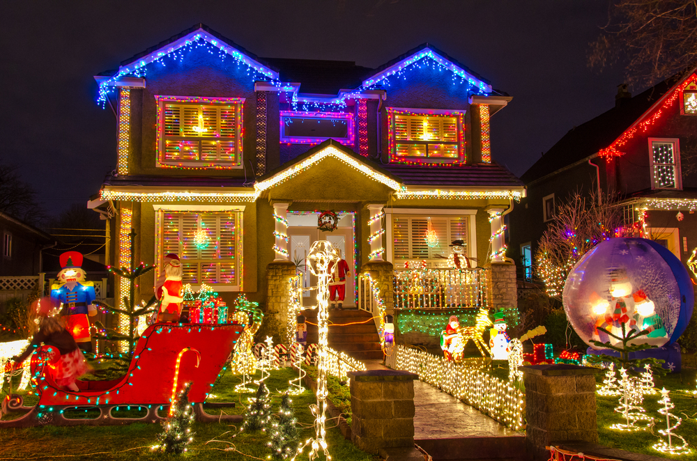 A large home with a yard filled with holiday decor