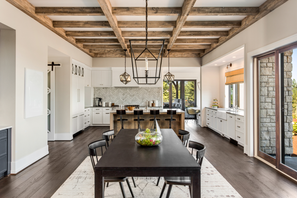 A kitchen and dining area with a wood beam “accent ceiling.”